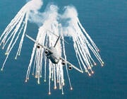 Boeing C-17 deploying flares over water