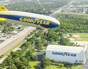 Goodyear blimp flying over highway