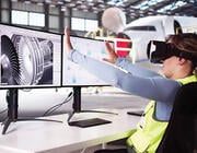 aerospace technician using a virtual reality headset to interact with 3D CAD models of an aircraft jet engine