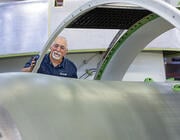 aviation maintenance technician working on a large aircraft engine nacelle