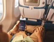 Hand holding smartphone with Alaska Airlines Starlink
