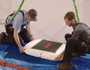 two people installing Starlink antenna on Bombardier Challenger 605