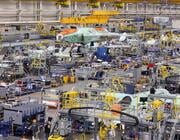 aircraft assembly factory with machinery and workers