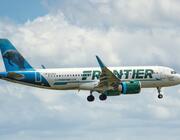 Frontier Airlines jet flying in sky