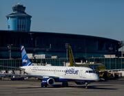 jetblue aircraft taxis at laguardia airport 