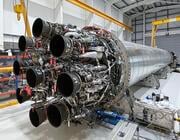 large space rocket engine displayed in an industrial hangar 
