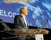 Lars Wagner speaking at podium with model Airbus A350F