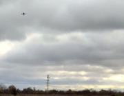 landscape featuring drone flying in cloudy sky