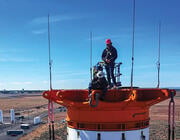 two people standing on top of rocket