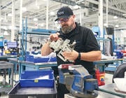 AJW Technique staff member conducting repair on part