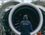 Air Astana employee standing in front of engine