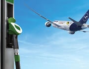 concept art of aircraft flying in background with sustainable aviation fuel pump in foreground