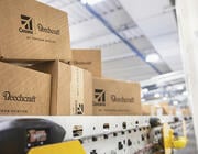 shipping boxes moving through a Textron Aviation automated conveyor facility
