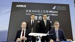 Airbus and China Southern leaders sign an agreement.