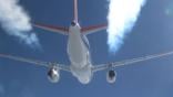 an airplane inflight with contrails