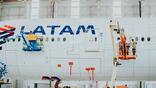 Lufthansa Technik employees work on a LATAM aircraft
