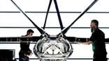 two people standing by 3D-printed aircraft fuselage